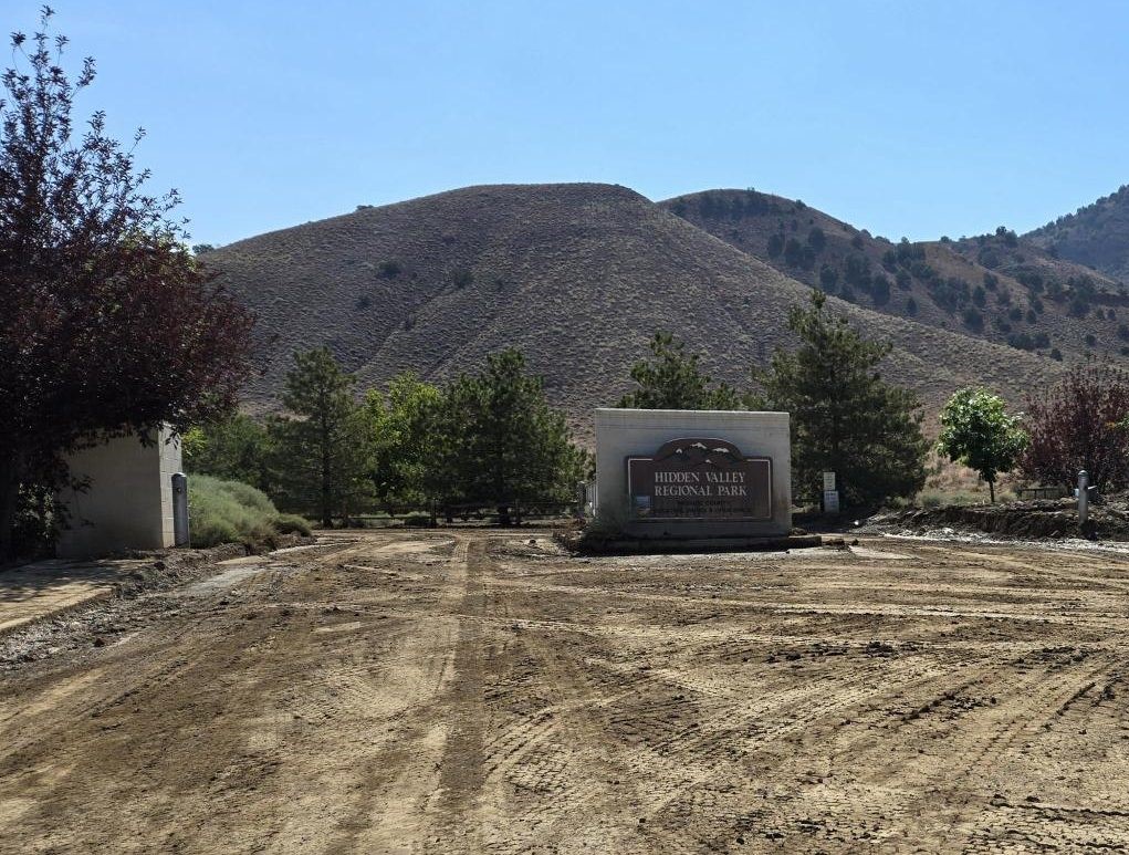 picture of muddy street and Hidden Valley Regional Park monument sign