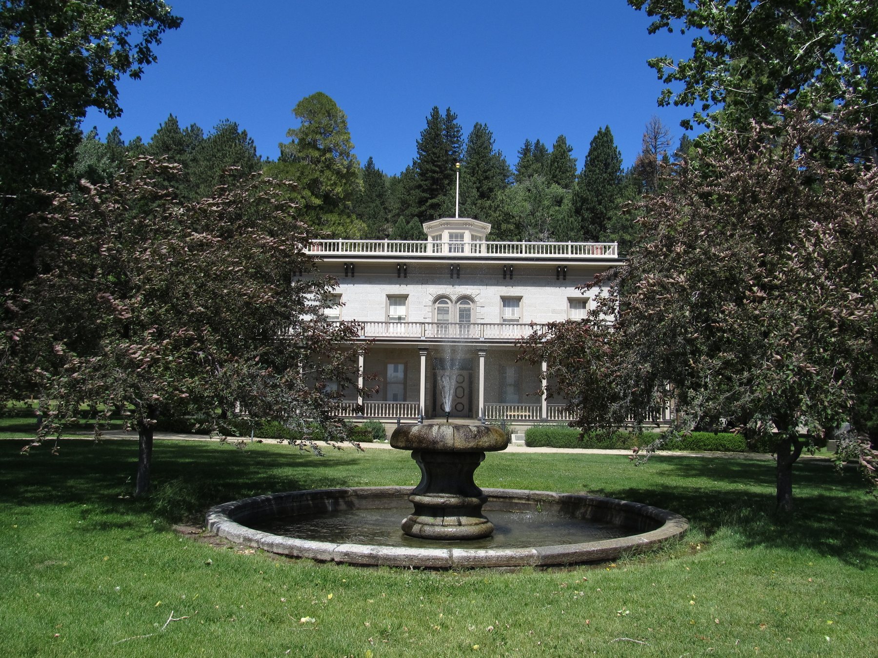 Front lawn and stone exterior of historic Bowers Mansion in Washoe Valley.