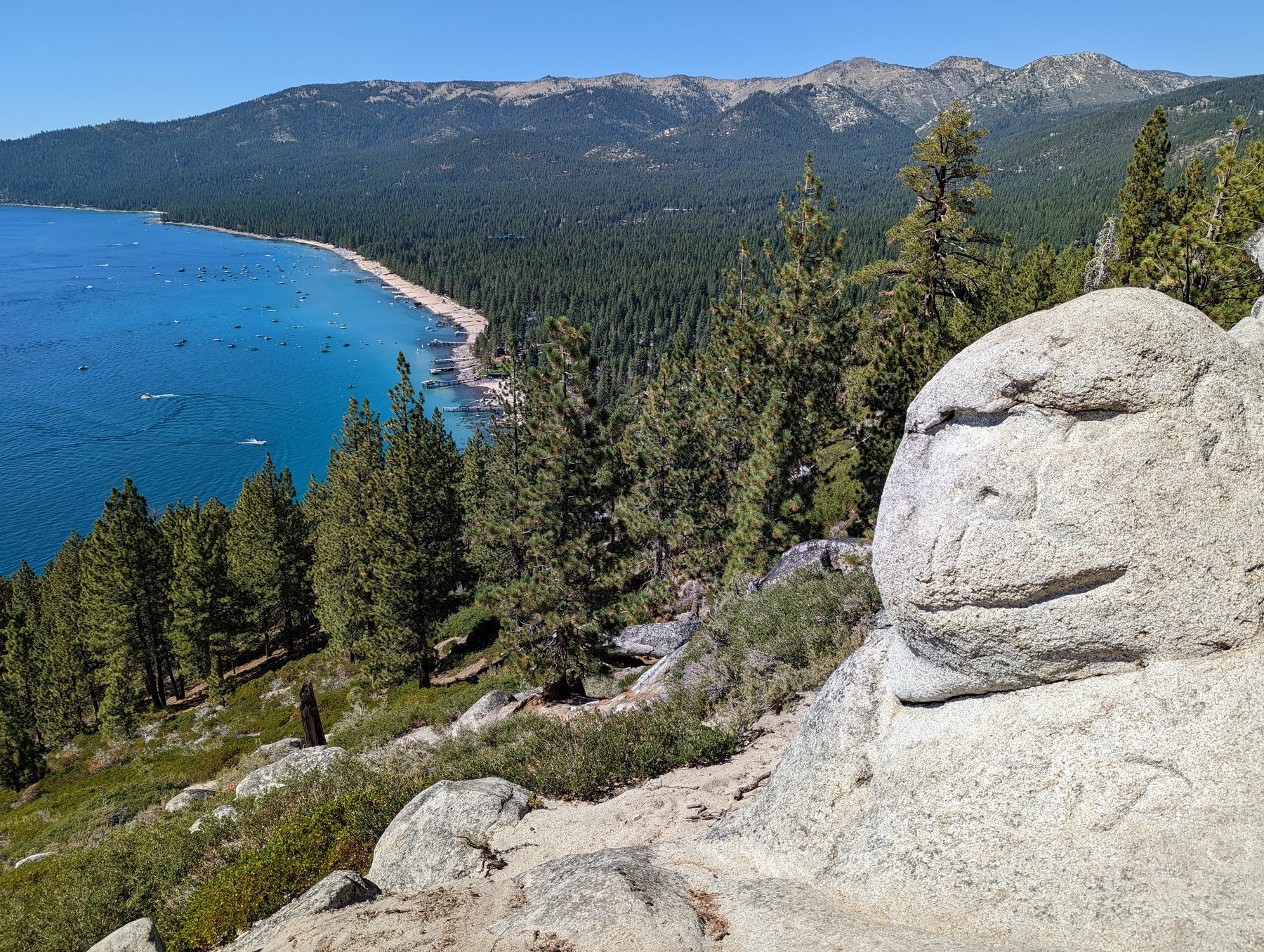 Lake Tahoe overlook from the Monkey Rock Trail with the granite landmark in the foreground.