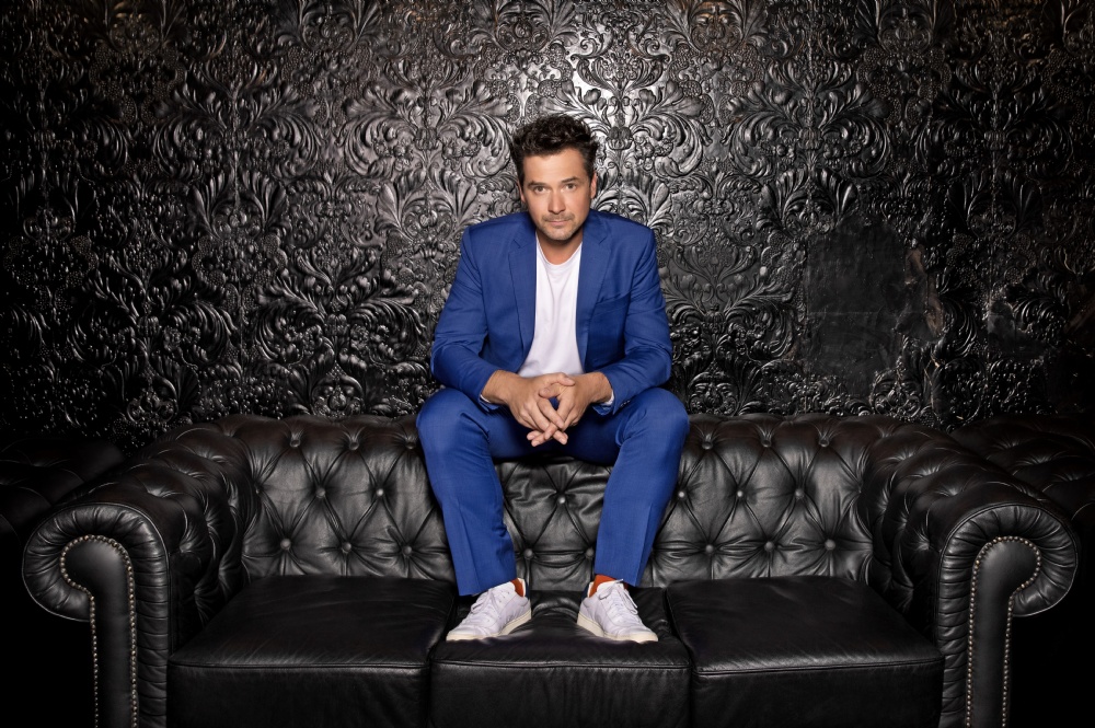 Michael Kaeshammer sitting on a couch