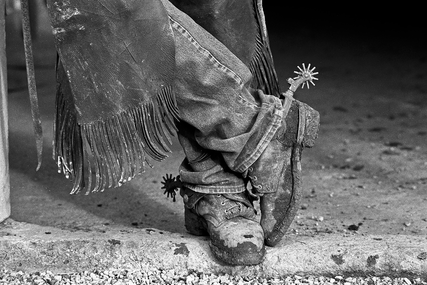 black and white image of crossed cowboy boots